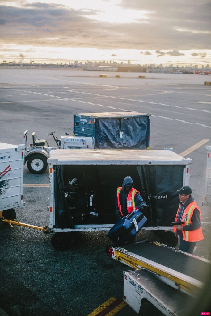Baggage handlers loading baggage onto aircraft